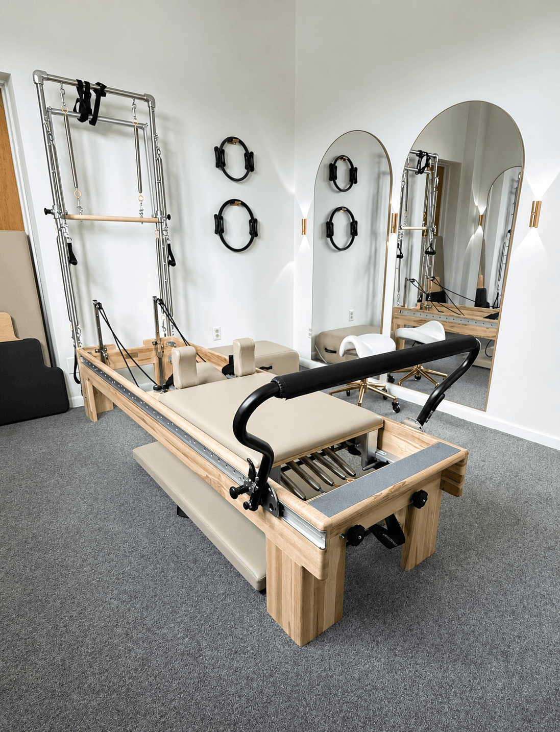 Atelier Pilates studio with reformers, tower equipment, and mirrors